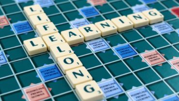 Scrabble game pieces spelling the phrase lifelong learning